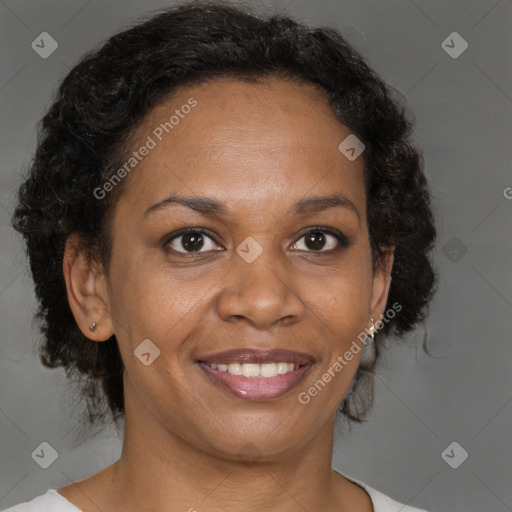 Joyful black adult female with medium  brown hair and brown eyes