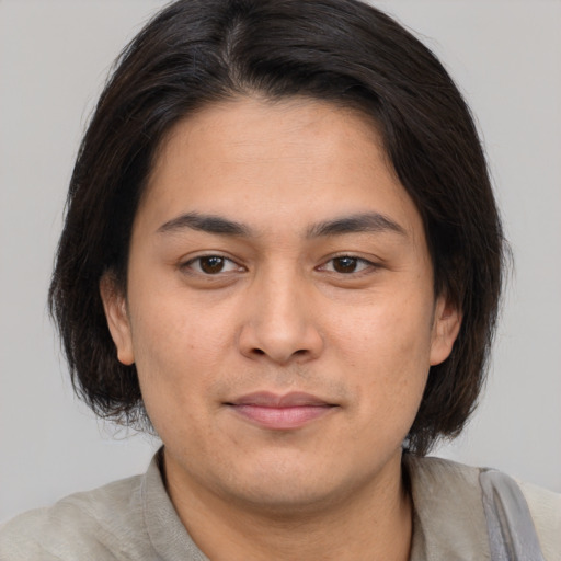 Joyful asian young-adult male with medium  brown hair and brown eyes