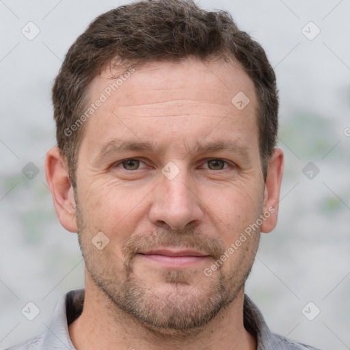 Joyful white adult male with short  brown hair and grey eyes