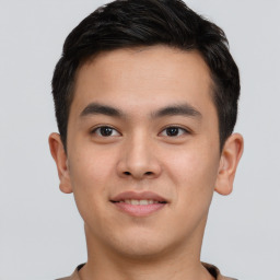 Joyful asian young-adult male with short  brown hair and brown eyes