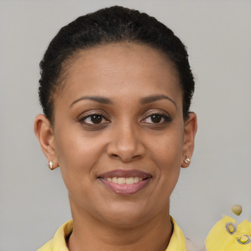 Joyful black young-adult female with short  brown hair and brown eyes