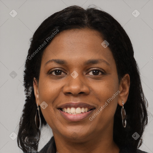 Joyful black young-adult female with long  brown hair and brown eyes