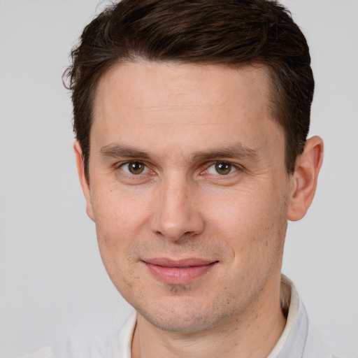 Joyful white adult male with short  brown hair and brown eyes