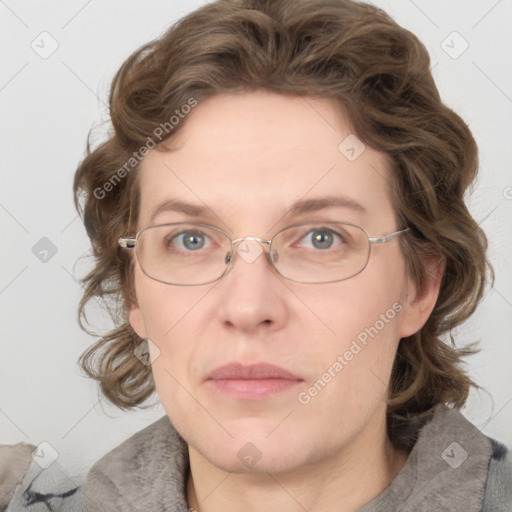 Joyful white adult female with medium  brown hair and blue eyes