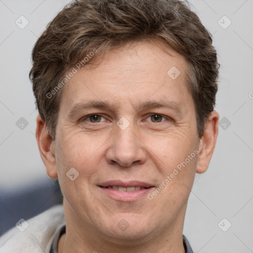 Joyful white adult male with short  brown hair and brown eyes