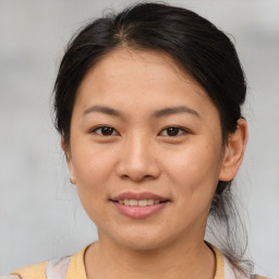 Joyful asian young-adult female with medium  brown hair and brown eyes