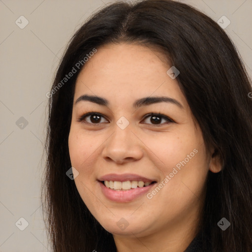 Joyful latino young-adult female with long  brown hair and brown eyes