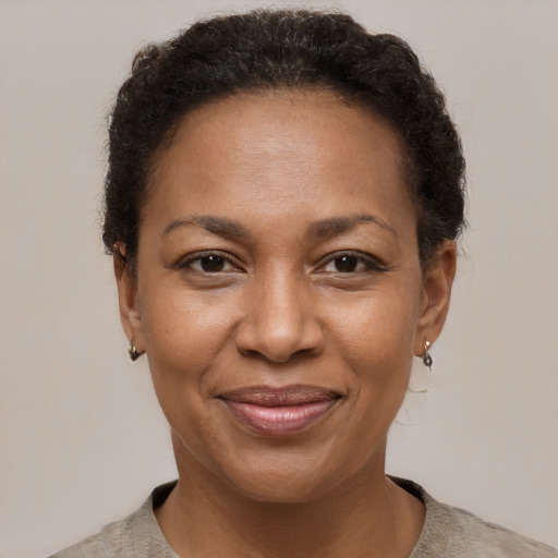 Joyful black adult female with short  brown hair and brown eyes