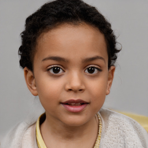 Joyful latino child female with short  brown hair and brown eyes