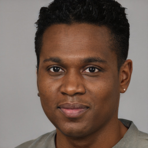 Joyful black young-adult male with short  black hair and brown eyes