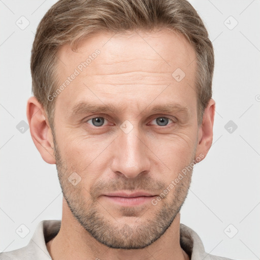 Joyful white adult male with short  brown hair and grey eyes