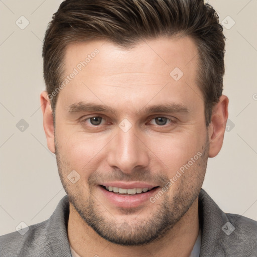 Joyful white young-adult male with short  brown hair and brown eyes