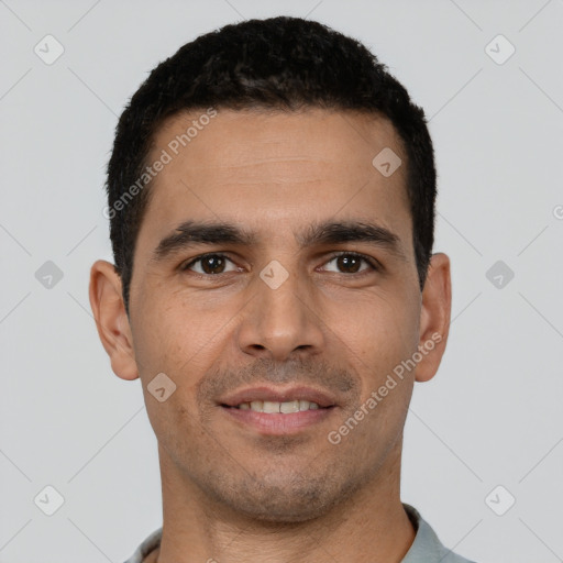 Joyful white young-adult male with short  black hair and brown eyes