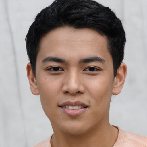 Joyful asian young-adult male with short  black hair and brown eyes