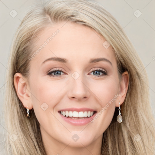 Joyful white young-adult female with long  brown hair and blue eyes