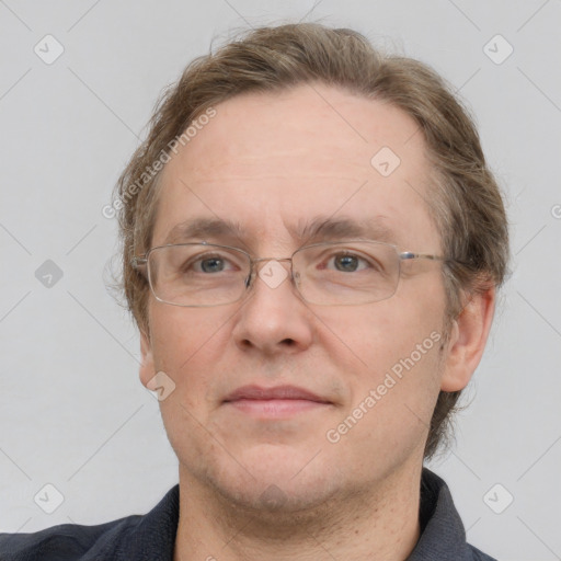 Joyful white adult male with short  brown hair and grey eyes