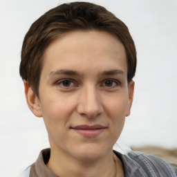 Joyful white young-adult female with short  brown hair and grey eyes