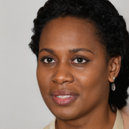 Joyful black young-adult female with short  brown hair and brown eyes