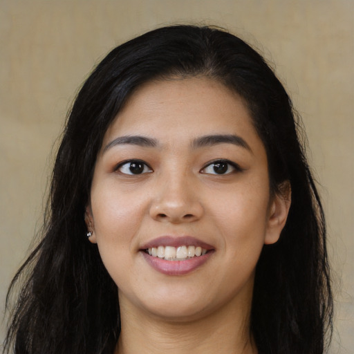 Joyful asian young-adult female with long  black hair and brown eyes