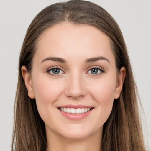 Joyful white young-adult female with long  brown hair and grey eyes