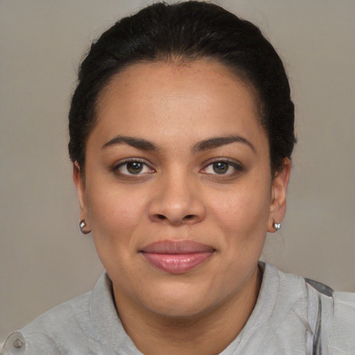 Joyful black young-adult female with short  brown hair and brown eyes