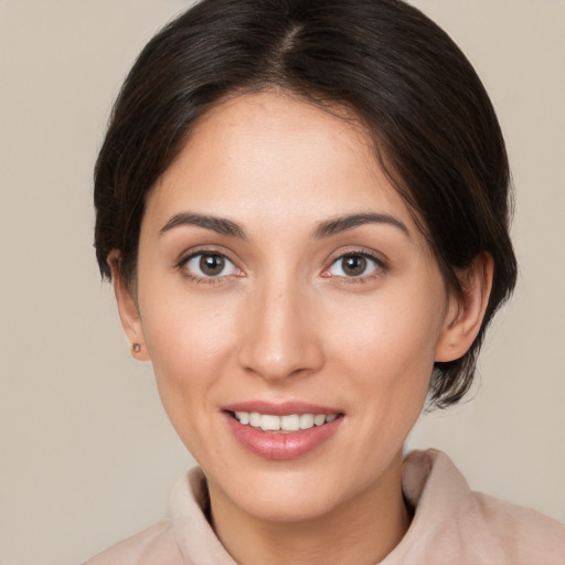 Joyful white young-adult female with medium  brown hair and brown eyes