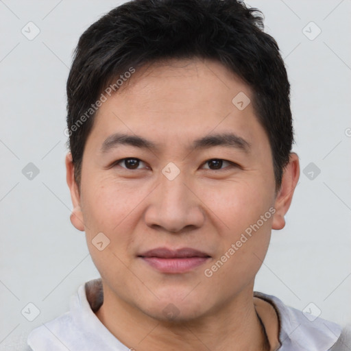 Joyful asian young-adult male with short  brown hair and brown eyes