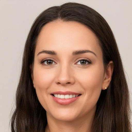 Joyful white young-adult female with long  brown hair and brown eyes