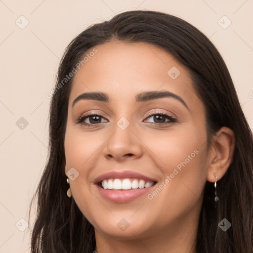 Joyful latino young-adult female with long  brown hair and brown eyes