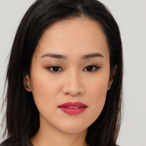 Joyful asian young-adult female with long  brown hair and brown eyes