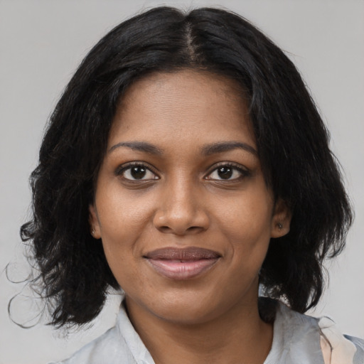Joyful black young-adult female with medium  black hair and brown eyes