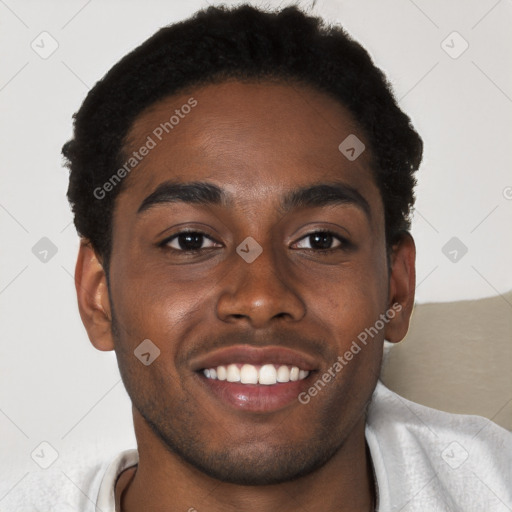 Joyful black young-adult male with short  brown hair and brown eyes