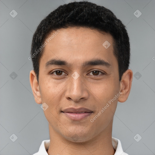 Joyful latino young-adult male with short  brown hair and brown eyes