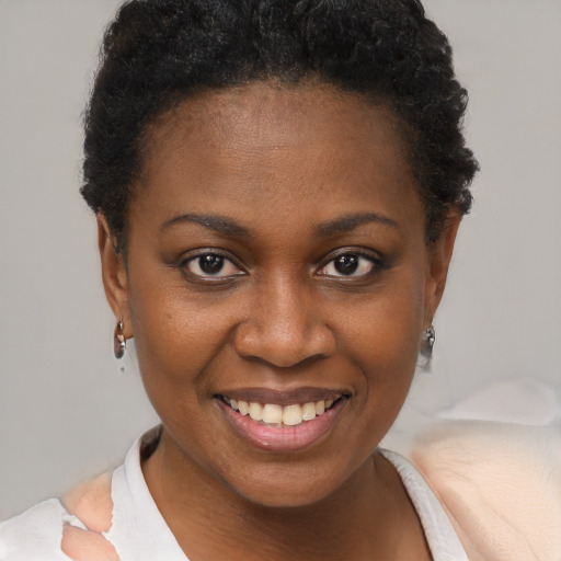 Joyful black young-adult female with short  brown hair and brown eyes