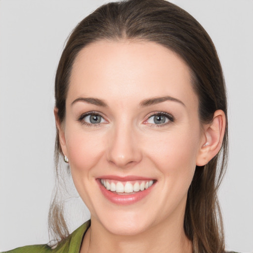 Joyful white young-adult female with long  brown hair and grey eyes