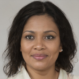 Joyful black adult female with medium  brown hair and brown eyes