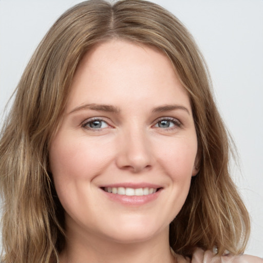 Joyful white young-adult female with medium  brown hair and green eyes