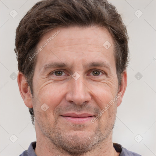 Joyful white adult male with short  brown hair and grey eyes