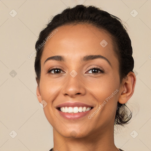 Joyful latino young-adult female with long  black hair and brown eyes