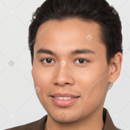 Joyful white young-adult male with short  brown hair and brown eyes