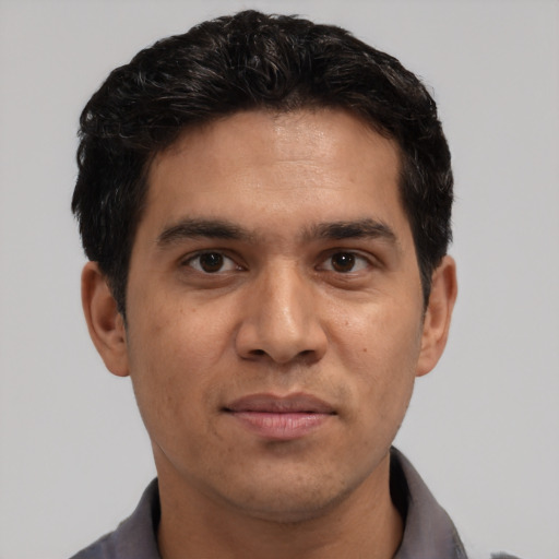 Joyful white young-adult male with short  black hair and brown eyes