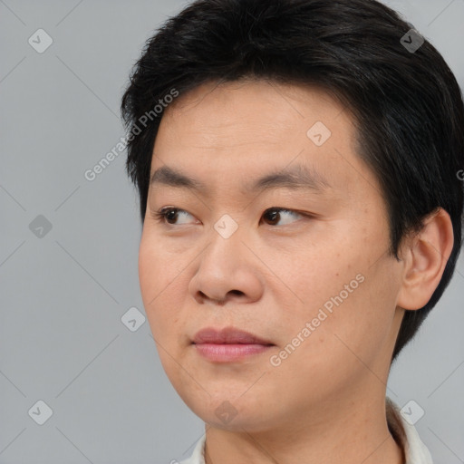 Joyful asian young-adult male with short  brown hair and brown eyes