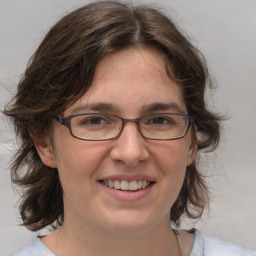 Joyful white adult female with medium  brown hair and brown eyes