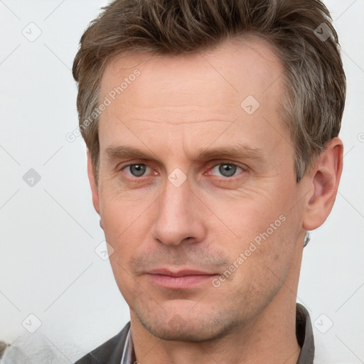 Joyful white adult male with short  brown hair and grey eyes