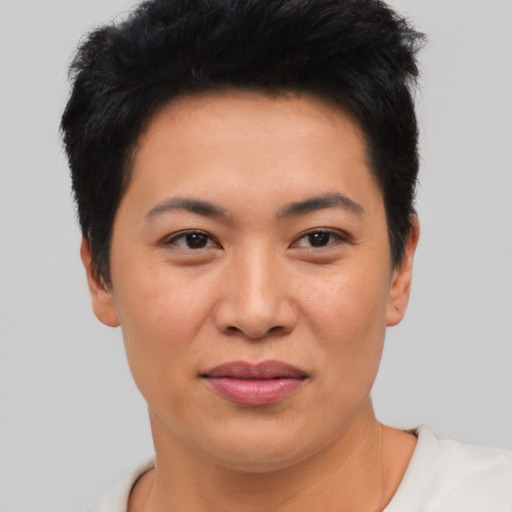 Joyful asian young-adult female with short  black hair and brown eyes
