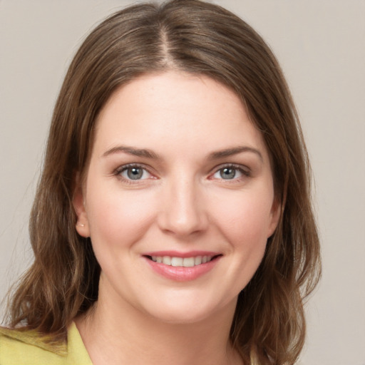 Joyful white young-adult female with medium  brown hair and grey eyes