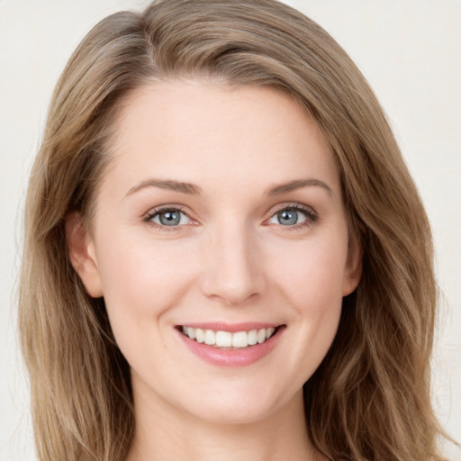 Joyful white young-adult female with long  brown hair and grey eyes