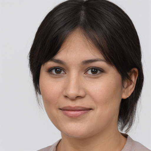 Joyful white young-adult female with medium  brown hair and brown eyes