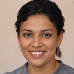 Joyful latino young-adult female with medium  brown hair and brown eyes