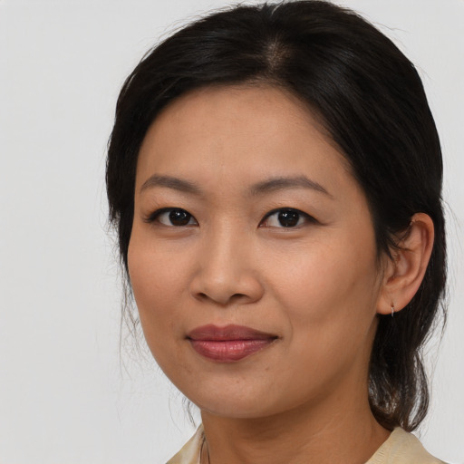 Joyful asian young-adult female with medium  brown hair and brown eyes